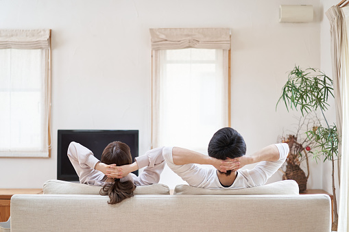 Asian men and women relaxing in the living room