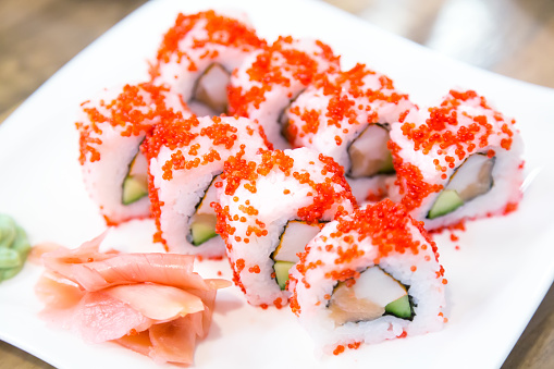 Asian Menu Californian Sushi Rolls With Masago Caviar Near Ginger And Wasabi On White Plate ...