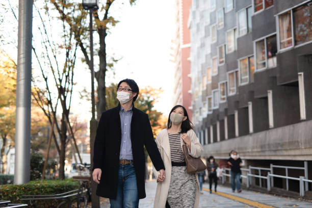 Asian mid-adult couple dating in downtown Asian mid-adult couple dating in downtown of Harajuku district, Tokyo, Japan mid adult couple stock pictures, royalty-free photos & images