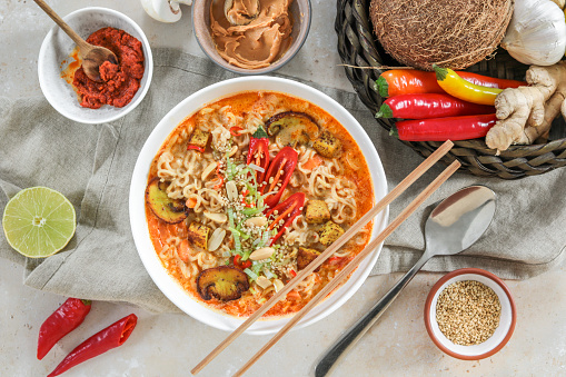 Asian Mie Noodle Soup with Tofu, Peanut, Lime and Chili as Flat Lay