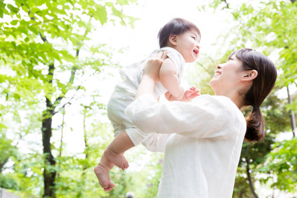 アジアの母と公園で赤ちゃん - 子供　笑顔 ストックフォトと画像