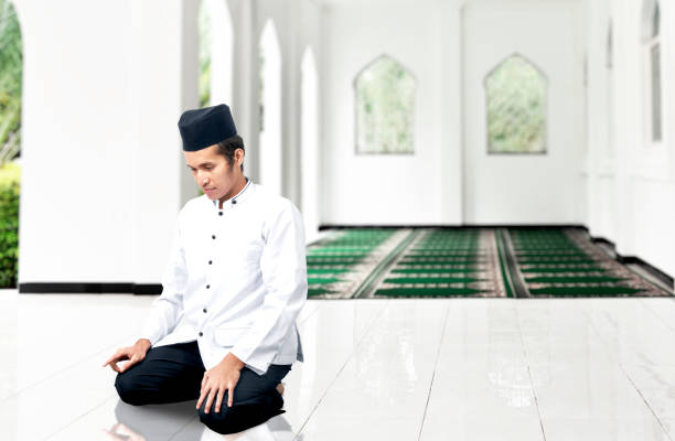 Asian Muslim man in praying position (salat) stock photo