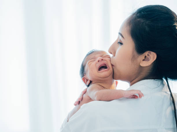 Asian newborn baby with mother stock photo