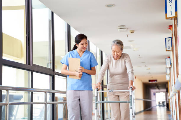 aziatische oude patiënt die wandelt gebruikend wandelaar in rehabilitatiecentrum - bejaardenhuis stockfoto's en -beelden