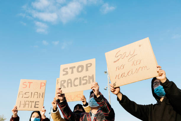 Asian people protest on the street against racism - Group of multiracial demonstrators from different asian countries fight for equal rights stock photo