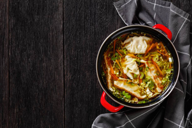 Asian Potsticker Soup in red pot, top view stock photo