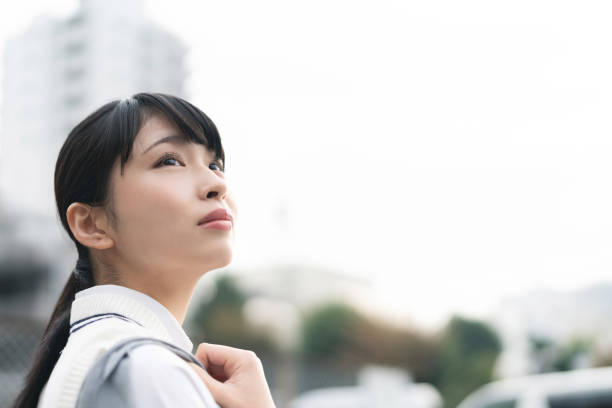 Asian school girl looking up to the sky. Asian school girl looking up to the sky. japanese girl stock pictures, royalty-free photos & images