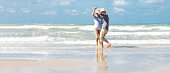 istock asian senior couple  dancing  on the beach 1322107306