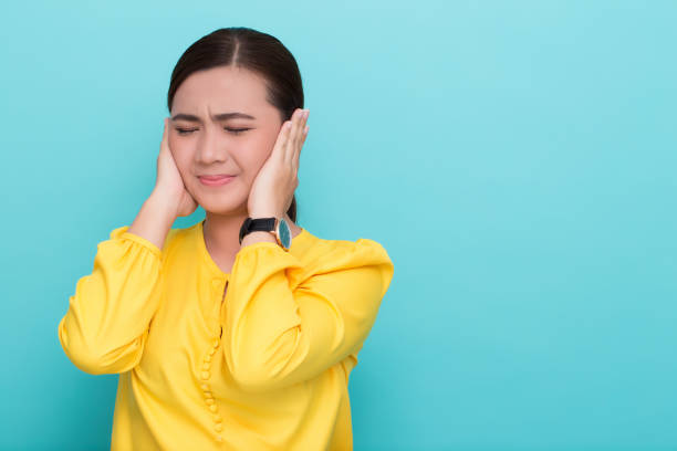 Asian woman close her ears stock photo