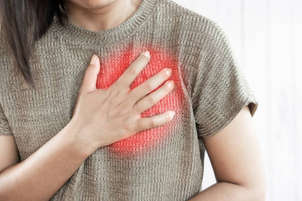 Asian woman having heart attack stock photo