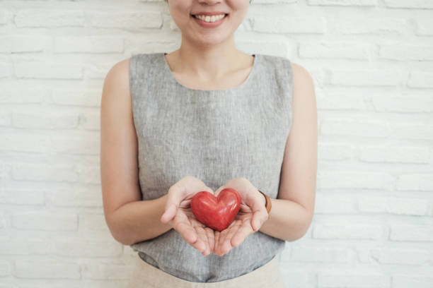 asian woman holding red heart, health insurance, donation charity concept - blood bar imagens e fotografias de stock