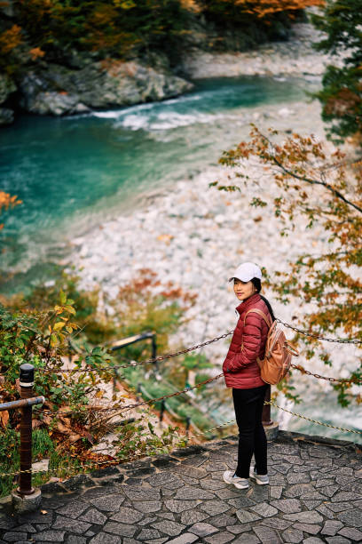 Asian woman is standing at view point  in Kurobe gorge, Toyama, Japan stock photo