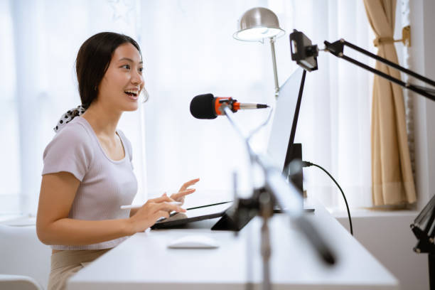 Asian woman Teaching online at home to students stock photo