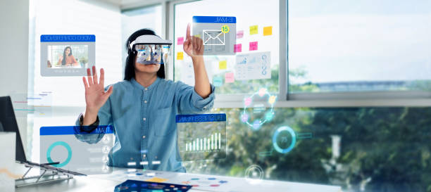 asian woman using augmented reality (ar) and Mixed reality glasses simulation meeting and working with hologram over table at office.virtual reality development process concept stock photo