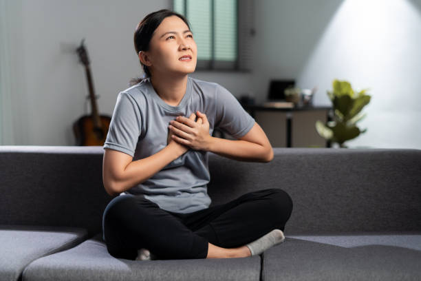 Asian woman was sick with chest pain. stock photo