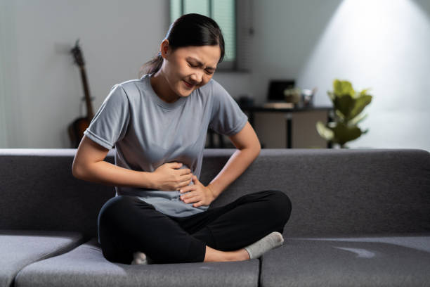 Asian woman was sick with stomachache. stock photo