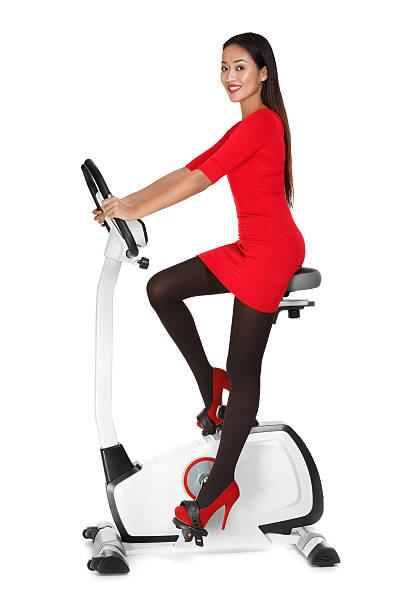 Asian woman working out on an exersice bike stock photo