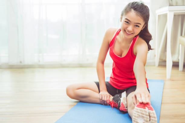 Asian women are exercising at home.She Warm ups
