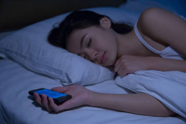 Asian Women Are Using The Smart Phone On The Bed Before She ...