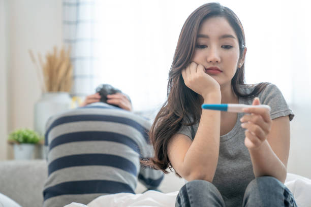 Asian women feel stressed after getting a pregnancy test, She was not ready to have children. stock photo