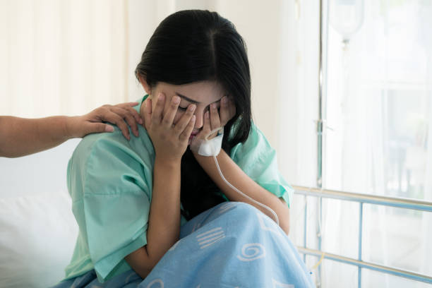 Asian young woman patient receiving bad news, Woman patient is desperate and crying. Her Mother support and comforting her patient with sympathy. stock photo
