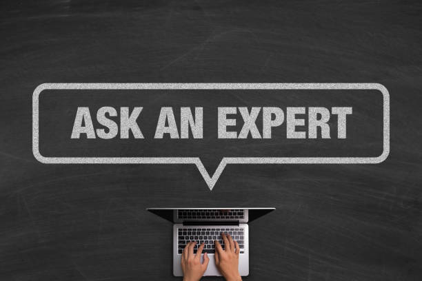 Ask An Expert Concept With Laptop On Blackboard stock photo