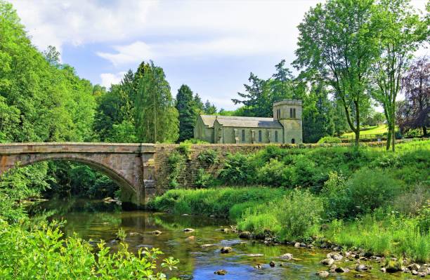 Askham Bridge and St Peter's Church 2, Askham, Penrith, Cumbria, England. A beautiful and picturesque English countryside village scene, in Penrith, Cumbria. cumbria stock pictures, royalty-free photos & images