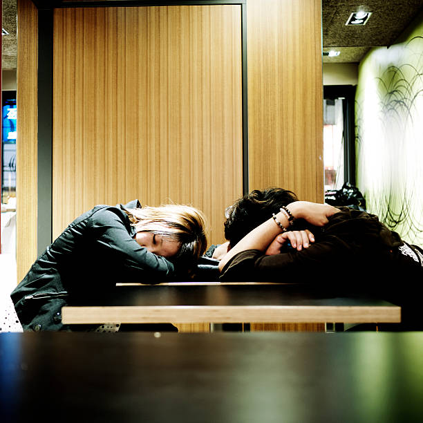 Asleep in McDonald's Tokyo, Japan - November 4, 2010: Two young women asleep on a table in a McDonald's Restaurant, Tokyo, Japan. mcdonalds japan stock pictures, royalty-free photos & images