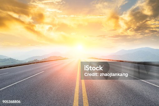 istock asphalt road and mountains with foggy landscape at sunset 905368806