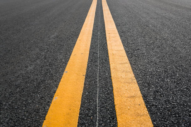Asphalt road with yellow double line Asphalt road with yellow double line dividing line road marking stock pictures, royalty-free photos & images