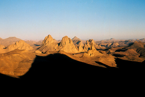 Assekrem in the hoggar at sunset with shadows in the foreground