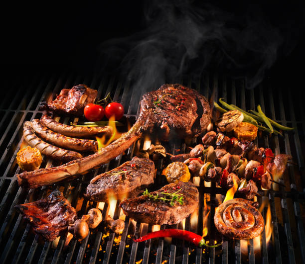 Assorted delicious grilled meat on a barbecue Assorted delicious grilled meat with vegetables over the coals on a barbecue cooked meat stock pictures, royalty-free photos & images