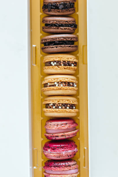 Assorted Gourmet Macaron Flavors Including Chocolate, Caramel, and Strawberry French macaron meringue based dessert. Assorted flavors of fruit, chocolate and caramel with chocolate chips and sprinkles semi sweet chocolate stock pictures, royalty-free photos & images