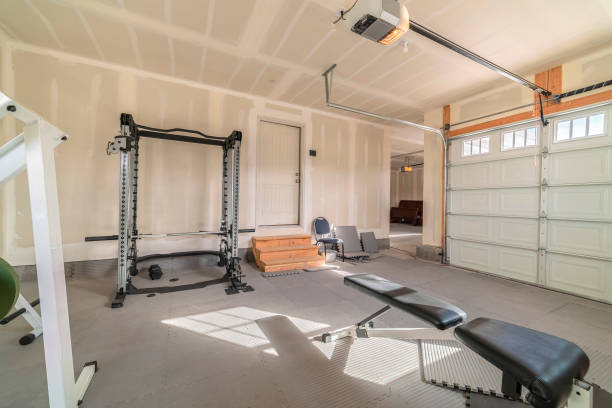 Assorted gym and fitness equipment in a garage stock photo