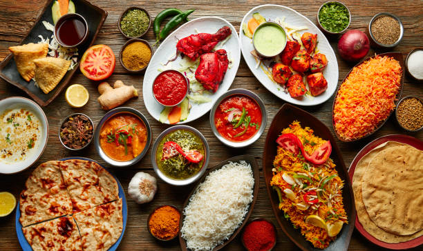 Assorted Indian recipes food various Assorted Indian recipes food various with spices and rice on wooden table indian food stock pictures, royalty-free photos & images