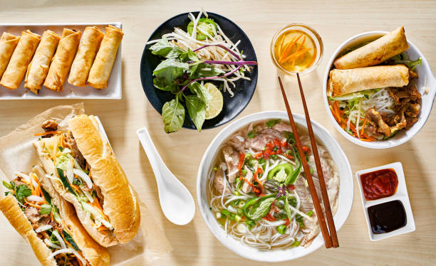 assorted vietnamese dishes with pho, bahn mi, spring rolls in top down composition stock photo