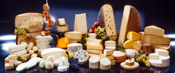 assortment of cheese large assortment of international cheese specialities on black background cheese stock pictures, royalty-free photos & images