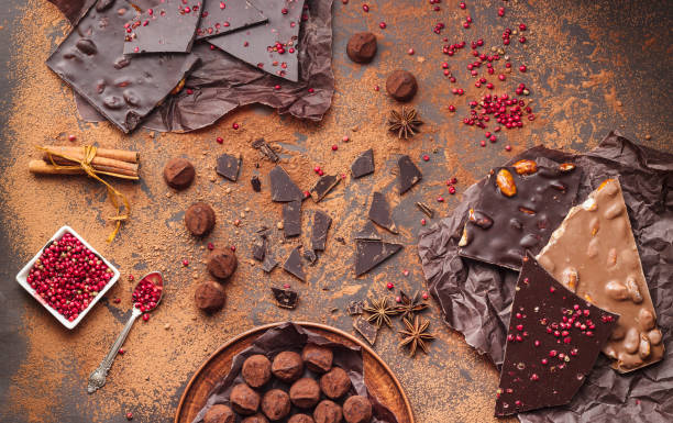 Assortment of chocolate bars, truffles, spices and cocoa powder stock photo
