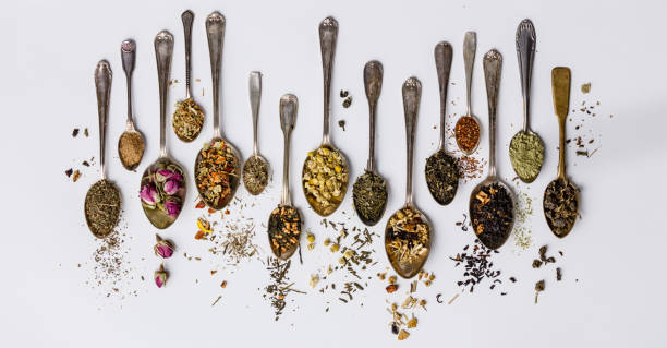 Assortment of dry tea in vintage spoons stock photo
