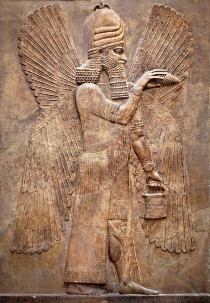 Assyrian wall relief of a winged genius Assyrian wall relief of a winged genius. Ancient carving panel from the Middle East history. Remains of the culture of ancient Assyrian and Sumerian civilization. Art of Mesopotamia. sumerian civilization stock pictures, royalty-free photos & images