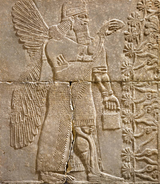 Assyrian wall relief of a winged genius with cuneiform Assyrian wall relief of a winged genius with cuneiform. Ancient carving panel from the Middle East history. Remains of the culture of ancient Assyrian and Sumerian civilization. sumerian civilization stock pictures, royalty-free photos & images