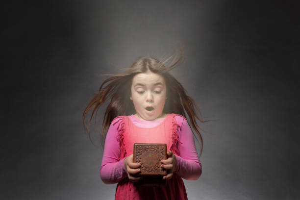 Astonished girl look in a box stock photo