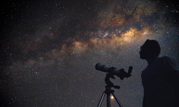 astronomer with a telescope watching at the stars and moon. my astronomy work. - céu olhar estrelas imagens e fotografias de stock