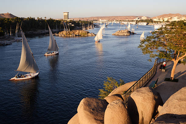 Aswan, Egypt Traditional boats sailing on the Nile river in Aswan, Egypt.     You'll find whatever else you need in this lightbox: Egypt  nile river stock pictures, royalty-free photos & images