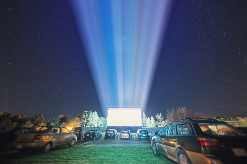 Drive in movie goers enjoy a screening under clear Autumn skies.  Long exposure.