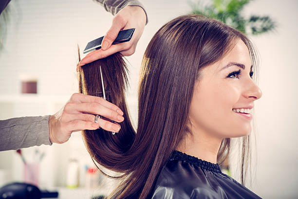 At The Hairdresser's Young beautiful woman having her hair cut at the hairdresser's. cutting hair stock pictures, royalty-free photos & images