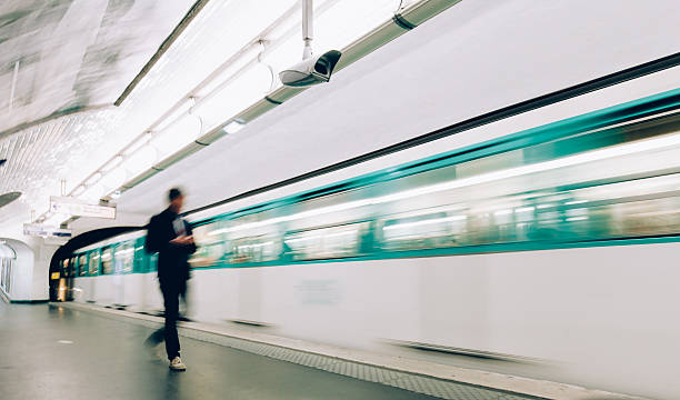 Man boarding train at metro station in Paris.