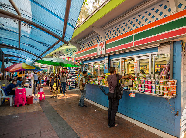 7-11 at Victory Monument, Thailand Bangkok, Thailand - Mar 10 , 2015: Unidentified peoples is buying something at mini 7-11 store in victory monument area. number 711 stock pictures, royalty-free photos & images