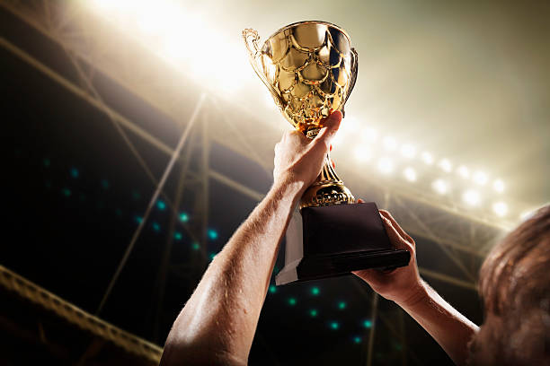 Athlete holding trophy cup stock photo
