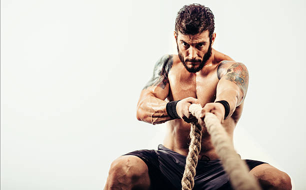 Athlete pulls a rope stock photo